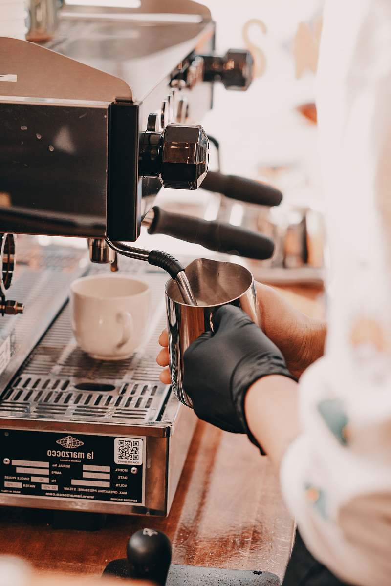 coffee cup person holding stainless steel pitcher cup